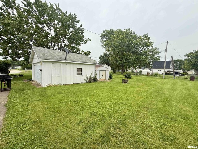 305 N Harshbarger St, Abingdon, IL 61410 - view of green lawn featuring a shed and a detached garage