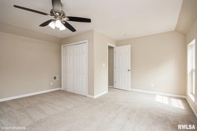 713 S Jackson St, Litchfield, IL 62056 - unfurnished bedroom featuring light carpet, a ceiling fan, a closet, and vaulted ceiling