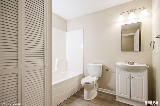 713 S Jackson St, Litchfield, IL 62056 - full bathroom featuring a closet, vanity, wood finished floors, and  shower combination
