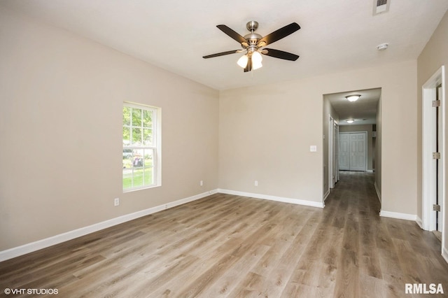 713 S Jackson St, Litchfield, IL 62056 - empty room with wood finished floors, a ceiling fan, and a smoke detector