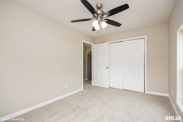 713 S Jackson St, Litchfield, IL 62056 - unfurnished bedroom featuring light colored carpet, a closet, and a ceiling fan