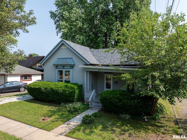 117 W Jefferson St, Macomb, IL 61455 - view of front of house featuring a front lawn, roof with shingles, and a porch