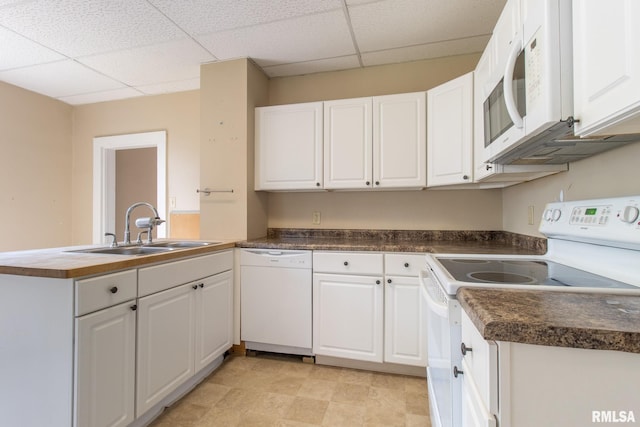 117 W Jefferson St, Macomb, IL 61455 - kitchen featuring white appliances, a drop ceiling, a peninsula, and white cabinetry