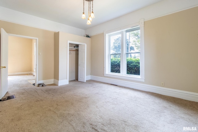117 W Jefferson St, Macomb, IL 61455 - unfurnished bedroom with light carpet and a closet