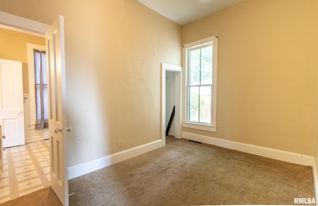 117 W Jefferson St, Macomb, IL 61455 - spare room featuring plenty of natural light and carpet