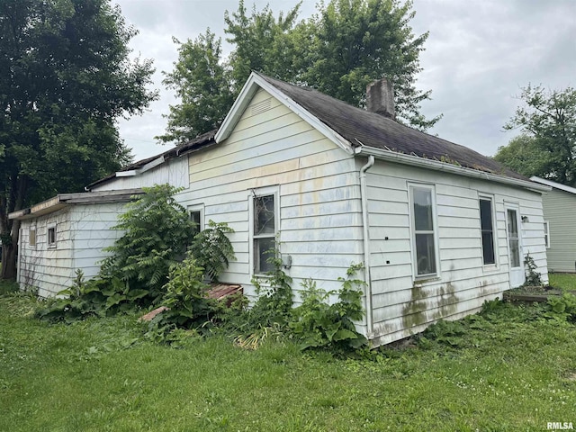 219 5th St, Lincoln, IL 62656 - view of side of property with a chimney and a yard