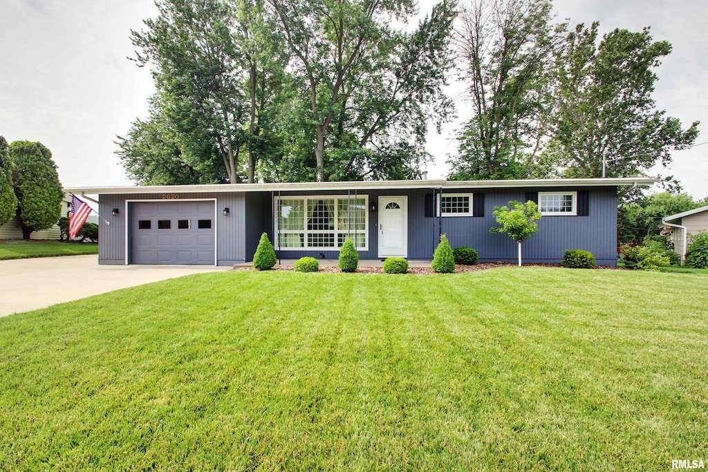 2620 Payson Rd, Quincy, IL 62305 - single story home featuring a garage, concrete driveway, and a front yard