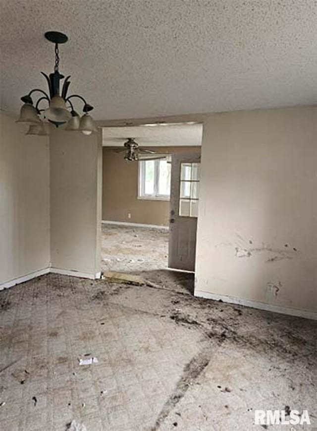 113 S Franklin St, Camp Point, IL 62320 - unfurnished room featuring a textured ceiling and a chandelier