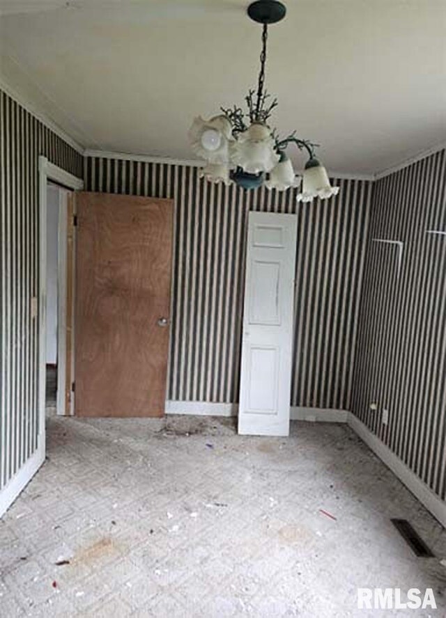 113 S Franklin St, Camp Point, IL 62320 - unfurnished dining area featuring a chandelier