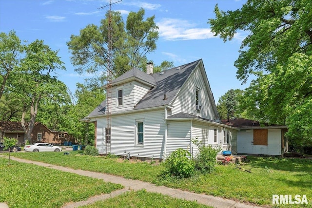1230 S 13th St, Springfield, IL 62703 - view of home's exterior featuring a yard, a chimney, and a shingled roof