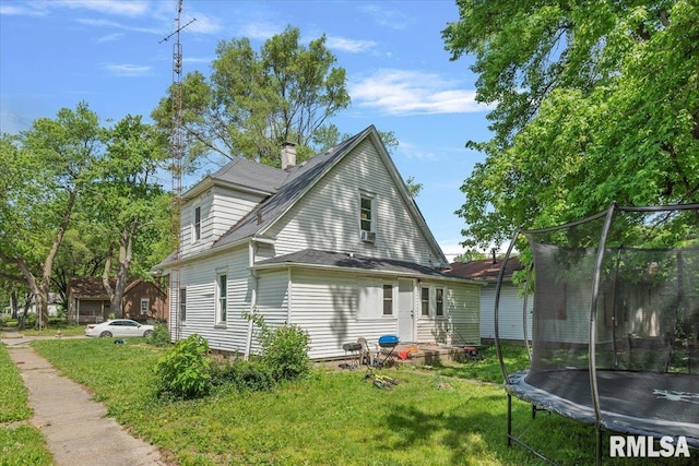 1230 S 13th St, Springfield, IL 62703 - rear view of property featuring a trampoline, a yard, and roof with shingles