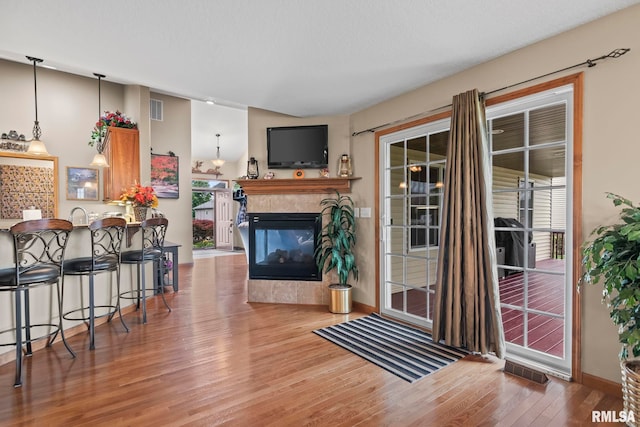 2308 Halifax Ave, Chatham, IL 62629 - living area featuring wood finished floors and a tiled fireplace