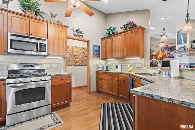 2308 Halifax Ave, Chatham, IL 62629 - kitchen with stainless steel appliances, a ceiling fan, tasteful backsplash, light wood-type flooring, and light stone counters