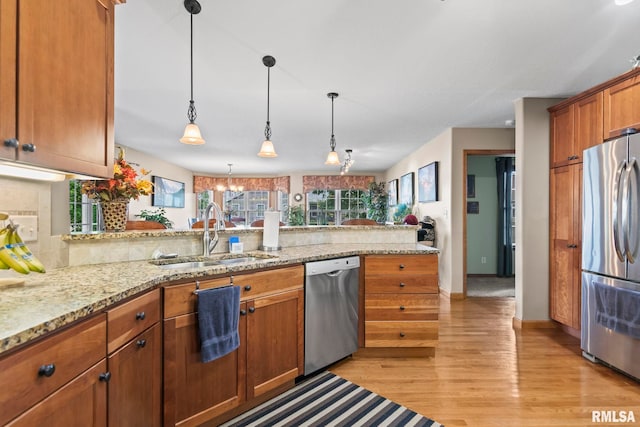 2308 Halifax Ave, Chatham, IL 62629 - kitchen featuring appliances with stainless steel finishes, brown cabinets, light wood-style floors, backsplash, and pendant lighting