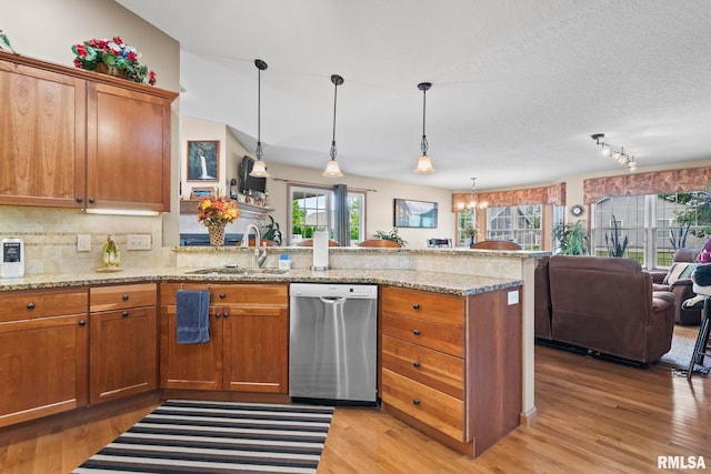 2308 Halifax Ave, Chatham, IL 62629 - kitchen featuring dishwasher, a peninsula, brown cabinetry, healthy amount of natural light, and a textured ceiling