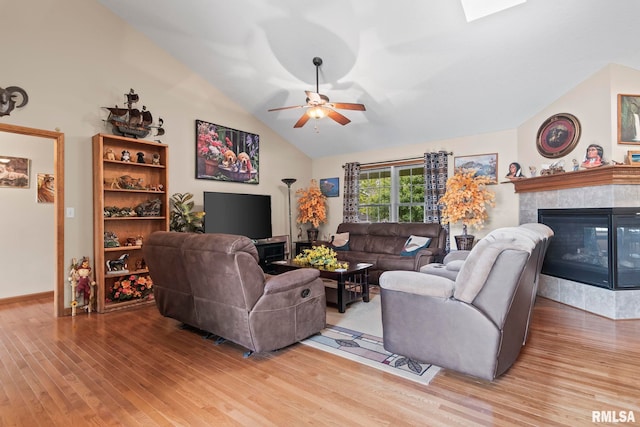 2308 Halifax Ave, Chatham, IL 62629 - living area featuring vaulted ceiling, wood finished floors, ceiling fan, and a tile fireplace