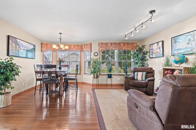 2308 Halifax Ave, Chatham, IL 62629 - dining space featuring a chandelier, wood finished floors, and a textured ceiling