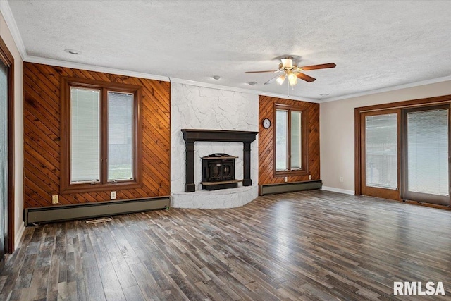 27 Twilight Ln, Springfield, IL 62712 - unfurnished living room featuring a baseboard heating unit, a textured ceiling, a ceiling fan, wood finished floors, and ornamental molding