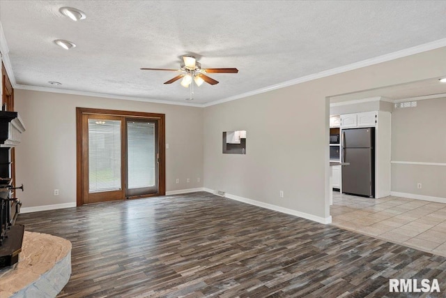 27 Twilight Ln, Springfield, IL 62712 - unfurnished living room featuring a ceiling fan, a textured ceiling, light wood-style flooring, crown molding, and a wood stove