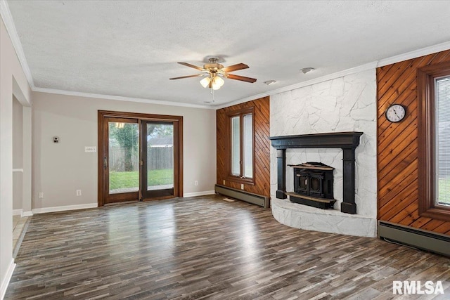 27 Twilight Ln, Springfield, IL 62712 - unfurnished living room featuring a baseboard heating unit, ceiling fan, wood finished floors, ornamental molding, and a textured ceiling