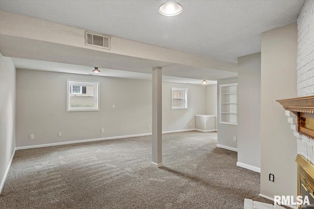 27 Twilight Ln, Springfield, IL 62712 - below grade area with a brick fireplace, carpet flooring, plenty of natural light, and a textured ceiling
