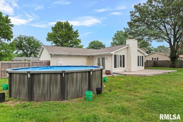27 Twilight Ln, Springfield, IL 62712 - rear view of house with a chimney, a fenced backyard, and a patio