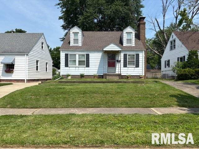 2136 N 6th St, Springfield, IL 62702 - new england style home with a front yard and a chimney