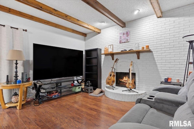 838 Hackberry Rd, Chatham, IL 62629 - living room with beam ceiling, wood finished floors, a textured ceiling, and a fireplace