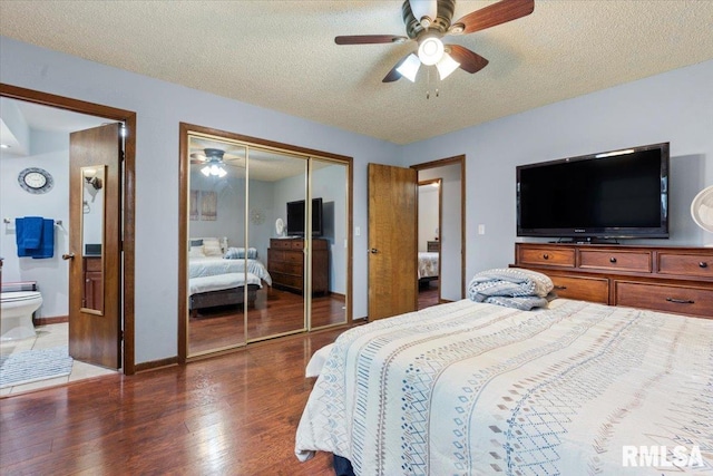838 Hackberry Rd, Chatham, IL 62629 - bedroom featuring wood finished floors, a closet, a textured ceiling, ensuite bathroom, and ceiling fan