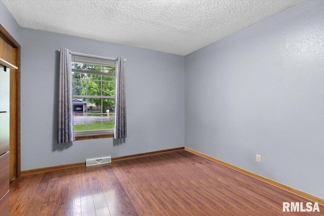 838 Hackberry Rd, Chatham, IL 62629 - spare room with hardwood / wood-style floors and a textured ceiling