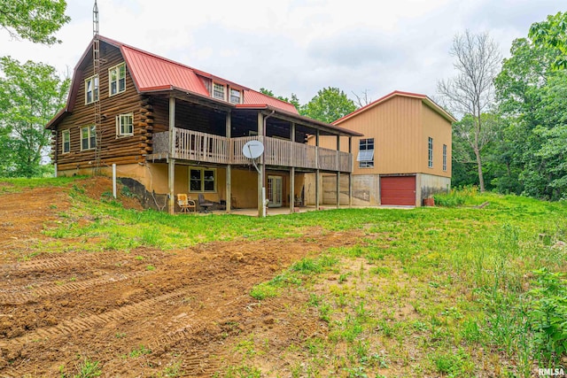 5190 Park Rd, Clinton, IL 61727 - rear view of property featuring a deck, an attached garage, log exterior, a metal roof, and a patio