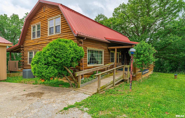 5190 Park Rd, Clinton, IL 61727 - log-style house featuring log exterior, a metal roof, a front lawn, and a gambrel roof