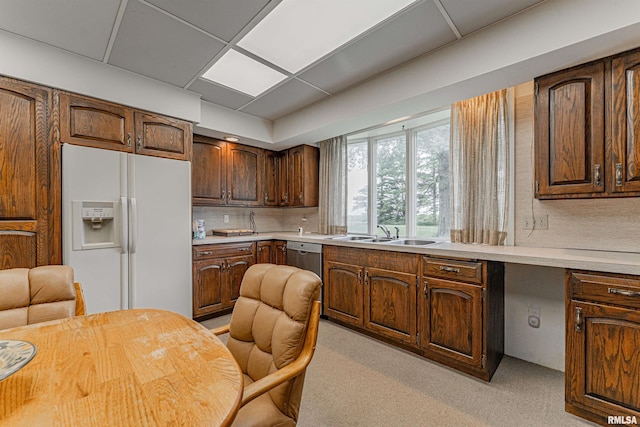 9320 Dawson Ln, Riverton, IL 62561 - kitchen with white fridge with ice dispenser, light countertops, light colored carpet, stainless steel dishwasher, and backsplash