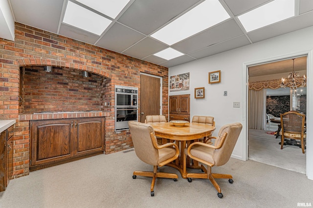 9320 Dawson Ln, Riverton, IL 62561 - dining room featuring a chandelier, a paneled ceiling, and light colored carpet