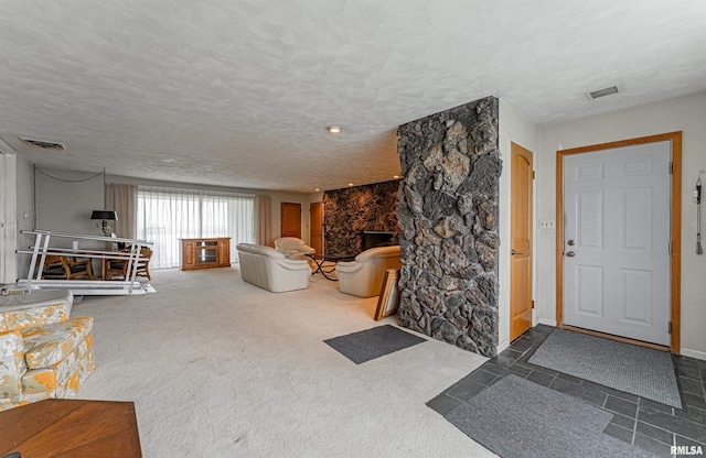 9320 Dawson Ln, Riverton, IL 62561 - carpeted living room with a stone fireplace and a textured ceiling
