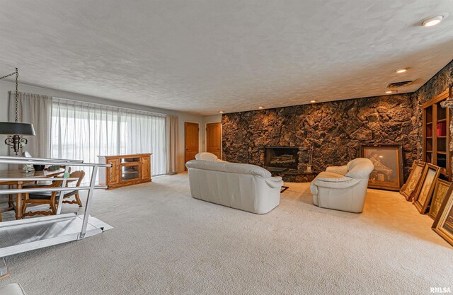 9320 Dawson Ln, Riverton, IL 62561 - living room with a stone fireplace, light colored carpet, and a textured ceiling
