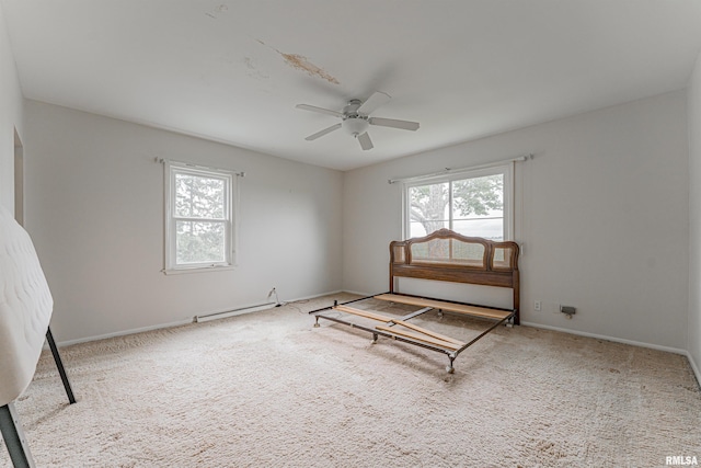 9320 Dawson Ln, Riverton, IL 62561 - unfurnished bedroom featuring carpet flooring, a ceiling fan, and a baseboard heating unit