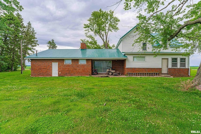 9320 Dawson Ln, Riverton, IL 62561 - back of house with a chimney, a lawn, brick siding, and a metal roof