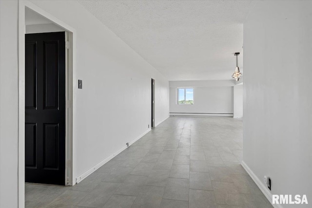 718 S 7th St Unit 1000, Springfield, IL 62703 - hallway featuring a baseboard radiator and a textured ceiling