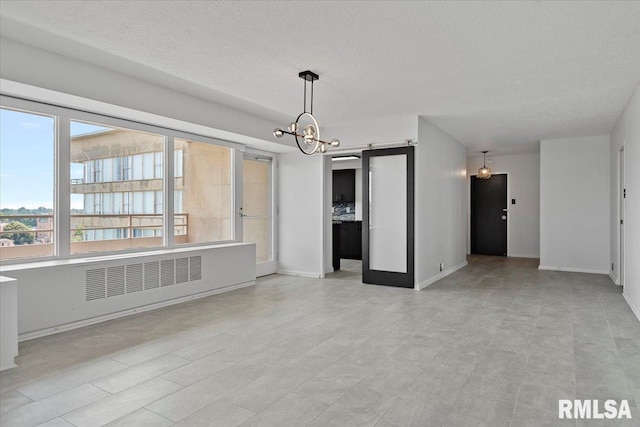 718 S 7th St Unit 1000, Springfield, IL 62703 - unfurnished living room featuring radiator heating unit, a chandelier, and a textured ceiling