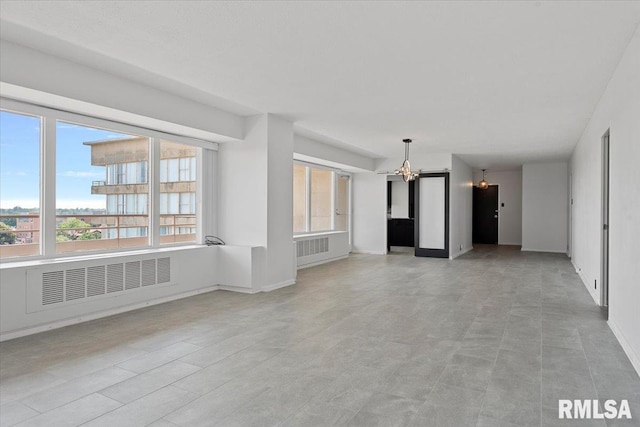 718 S 7th St Unit 1000, Springfield, IL 62703 - unfurnished living room with a chandelier and healthy amount of natural light