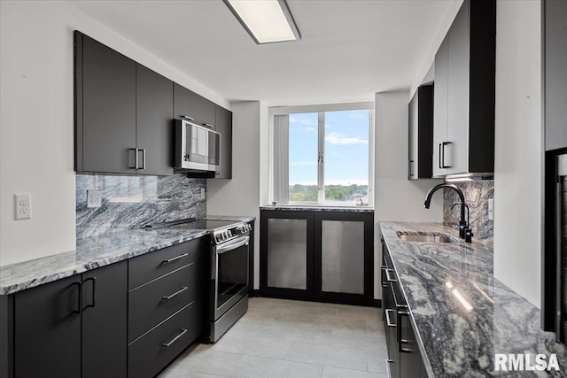 718 S 7th St Unit 1000, Springfield, IL 62703 - kitchen with stainless steel appliances, stone countertops, backsplash, and dark cabinets