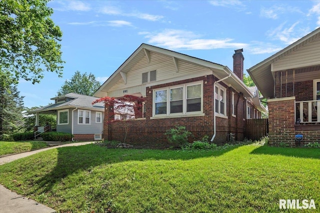 2141 S 4th St, Springfield, IL 62703 - view of front of house featuring a front yard, brick siding, and a chimney