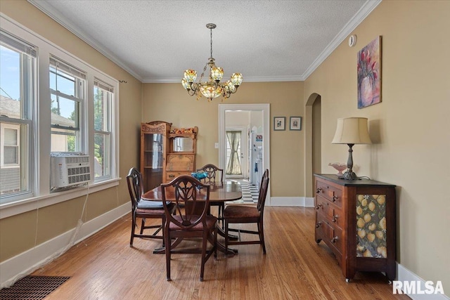 2141 S 4th St, Springfield, IL 62703 - dining space with arched walkways, wood finished floors, a chandelier, ornamental molding, and a textured ceiling
