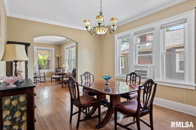 2141 S 4th St, Springfield, IL 62703 - dining room with arched walkways, healthy amount of natural light, wood finished floors, crown molding, and a textured ceiling