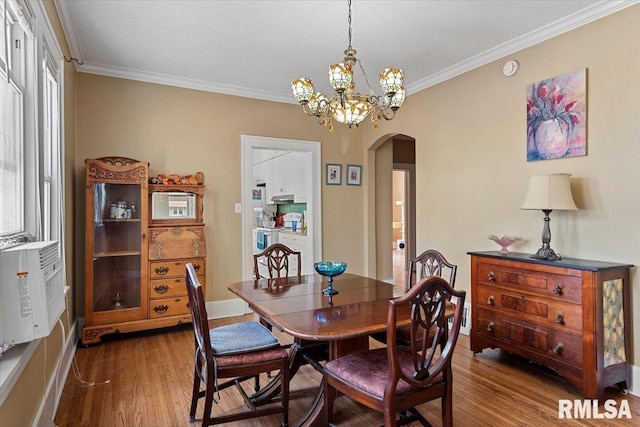 2141 S 4th St, Springfield, IL 62703 - dining area with arched walkways, dark wood finished floors, ornamental molding, a chandelier, and a textured ceiling