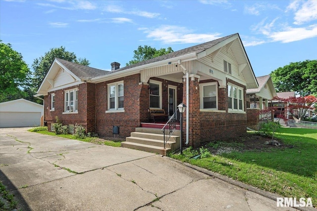 2141 S 4th St, Springfield, IL 62703 - view of front of property featuring covered porch, an outbuilding, brick siding, and a garage
