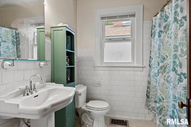 2141 S 4th St, Springfield, IL 62703 - bathroom with tile walls, a shower with curtain, and tile patterned flooring