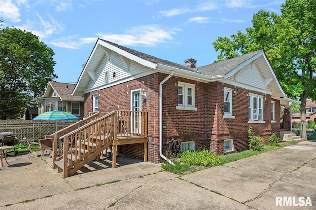 2141 S 4th St, Springfield, IL 62703 - view of home's exterior featuring brick siding, a chimney, and a patio
