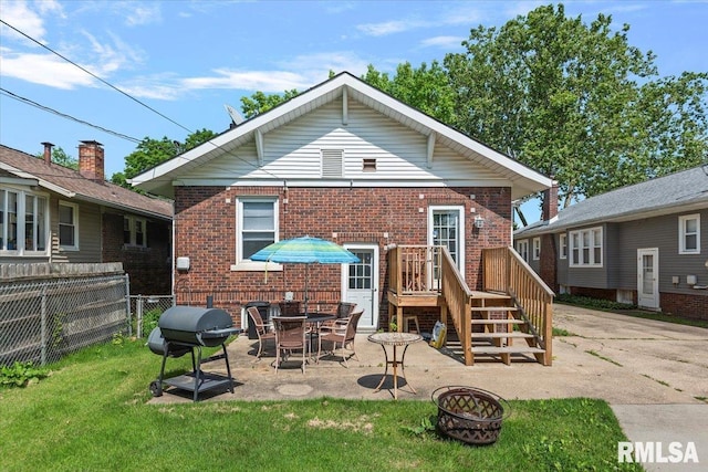 2141 S 4th St, Springfield, IL 62703 - back of property featuring a fire pit, brick siding, and a patio